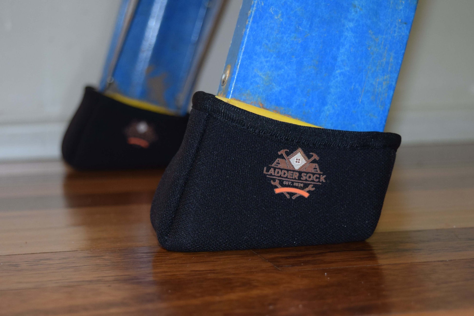 Black ladder sock with logo on a wooden floor